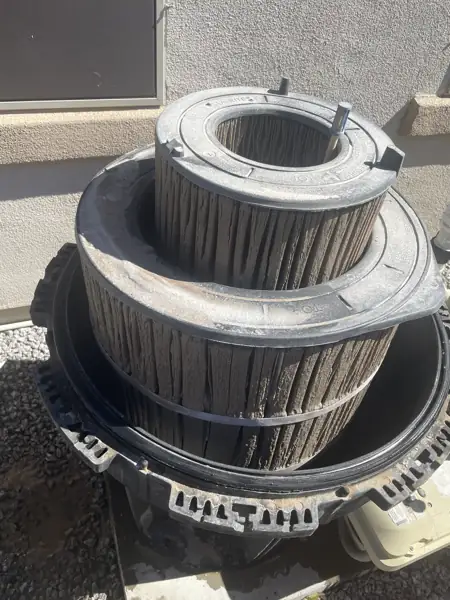 Filter cartridge before cleaning, dark with debris