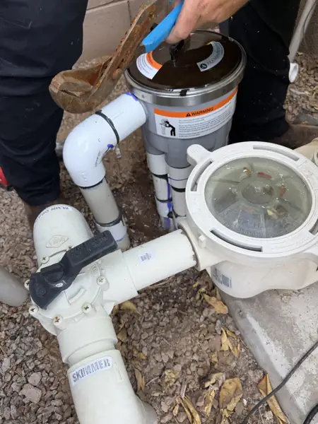 Spencer working on pool plumbing at the equipment pad